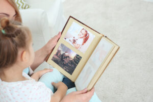 grandmother looking at photo album with her grandchild