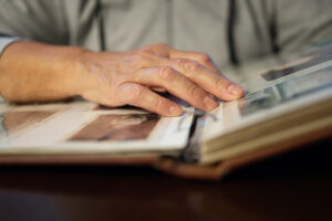 old woman looking at family photo album